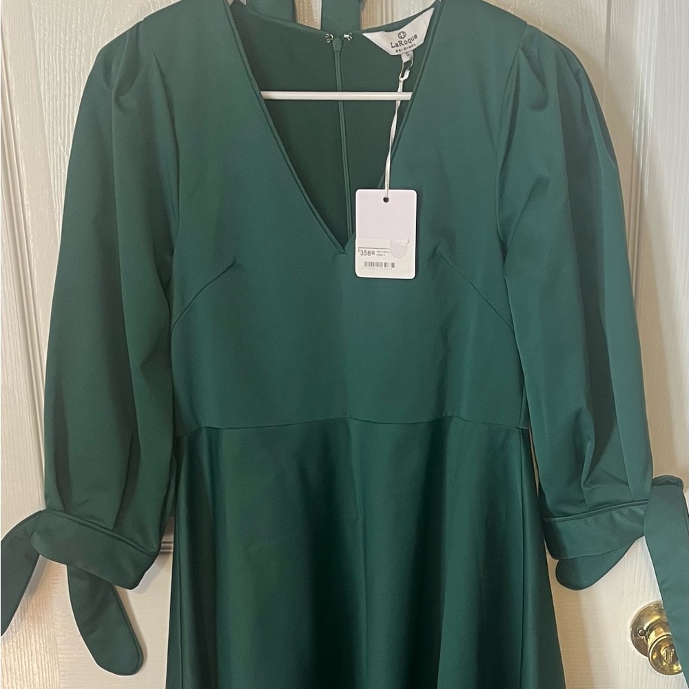 Beautiful emerald green dress. 100% polyester with lining. Dry clean only.